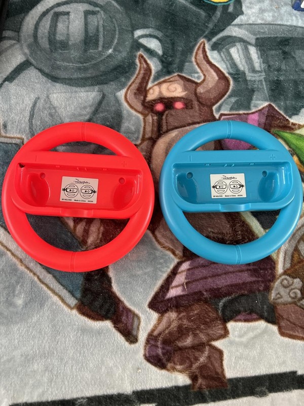 Pair of Red and Blue Plastic Steering Wheel Controllers for Video Games