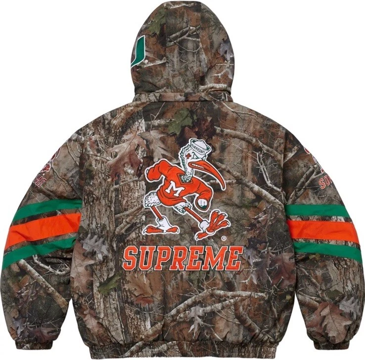 EN MAIN petite veste de stade à capuche Supreme Mitchell & Ness NCAA camouflage Miami ?
