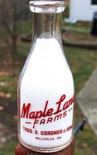 Real Nice Red Pyro Maple Lane Farm from Millville Pa. round quart milk bottle