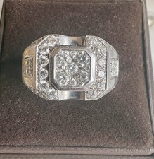 A square shaped diamond set cluster ring with diamond set shoulders In 18ct Gold