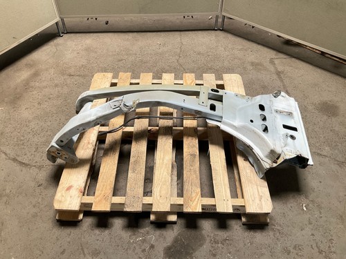 Silver 13-18 RAM 1500 front left driver frame apron radiator support on wooden pallet.