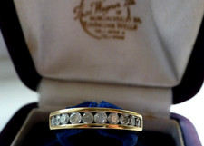 9 CT GOLD AND 12 NATURAL DIAMONDS ETERNITY RING SIZE "L" BEAUTIFULLY SET.
