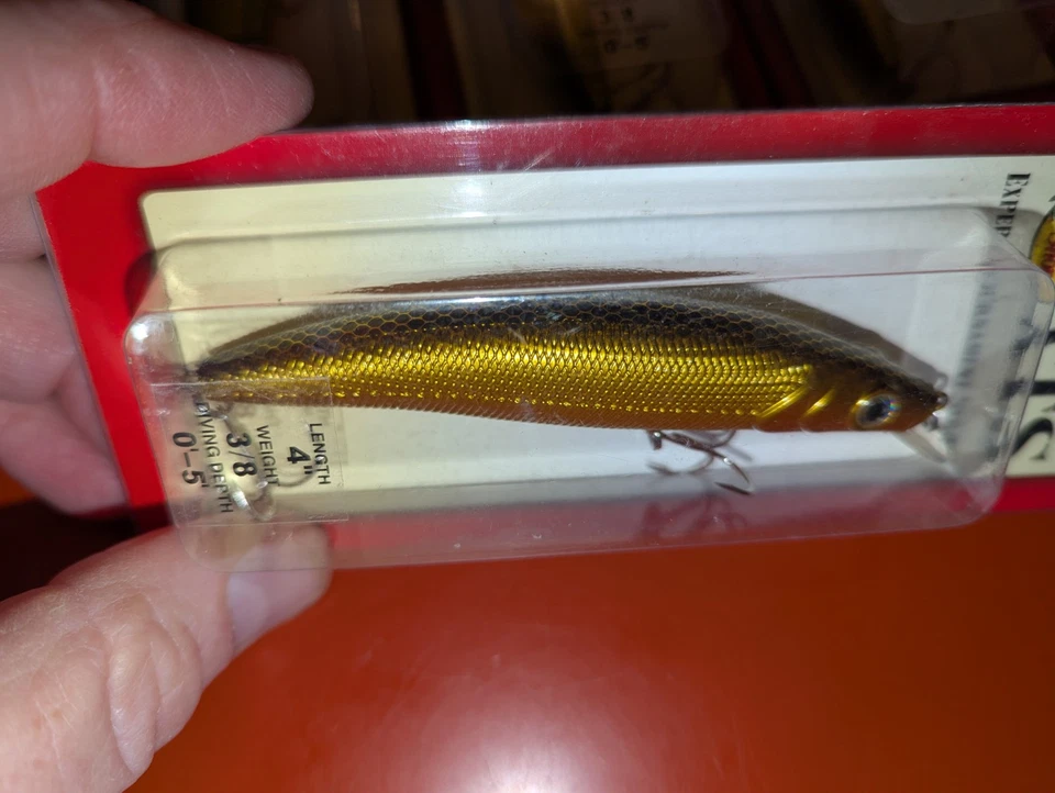 (6) Isca de pesca Bass Pro Shops XTS plugue lápis ouro preto 4" 3/8 oz #AI100-52 - Imagem 3 de 4