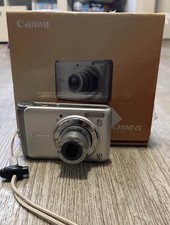 A: Canon PowerShot A3100 IS 12.1MP 4X - TESTED Silver - Extra Added Items