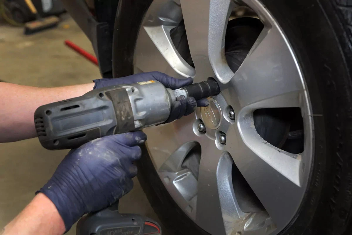 Installing wheel lug nuts with an impact gun.