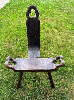 antique wooden three-legged birthing chair