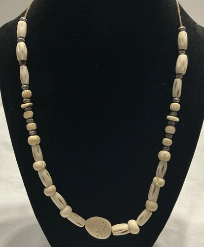 OFF WHITE Vintage Off White Carved Beads On A 30 Inch Brown Cord