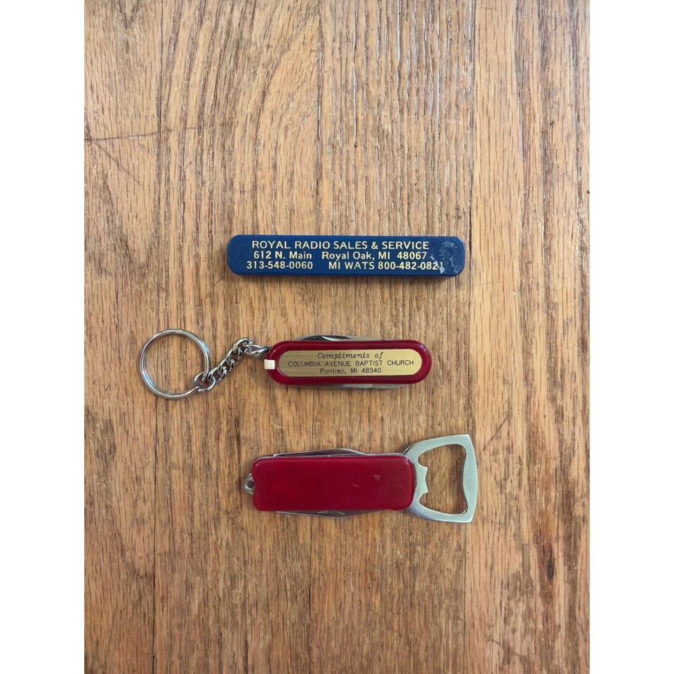 A trio of vintage advertising multi-tools — each one a tiny branded artifact from a bygone era of American commerce, pocket-sized and actually useful.