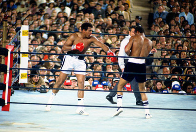 Mohammad Ali left throws a punch at Ken Norton right at the WBC W- 1976 Photo