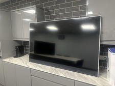 Sky Glass 65-inch 4K QLED Smart TV with Stand and a wall mount.