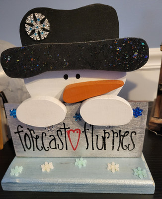 Snowman cutout, Forecast flurries sign, Winter theme with snowflakes.