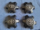 Set of 4 OEM 2016-2023 Toyota Tacoma Dark Charcoal center caps P/N 4260B-04050