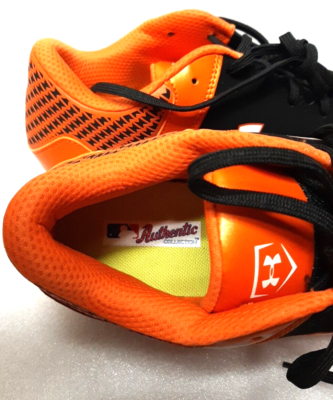 orange and black under armour baseball cleats