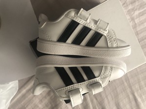 white tennis shoes with black stripes