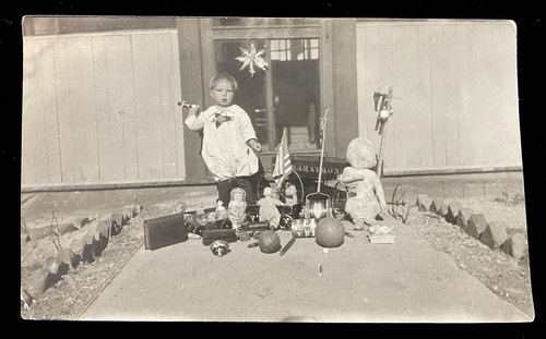TOYS CHILD POSED WITH GREAT TOY COLLECTION DOLLS WAGON TOP TRAIN BALL
