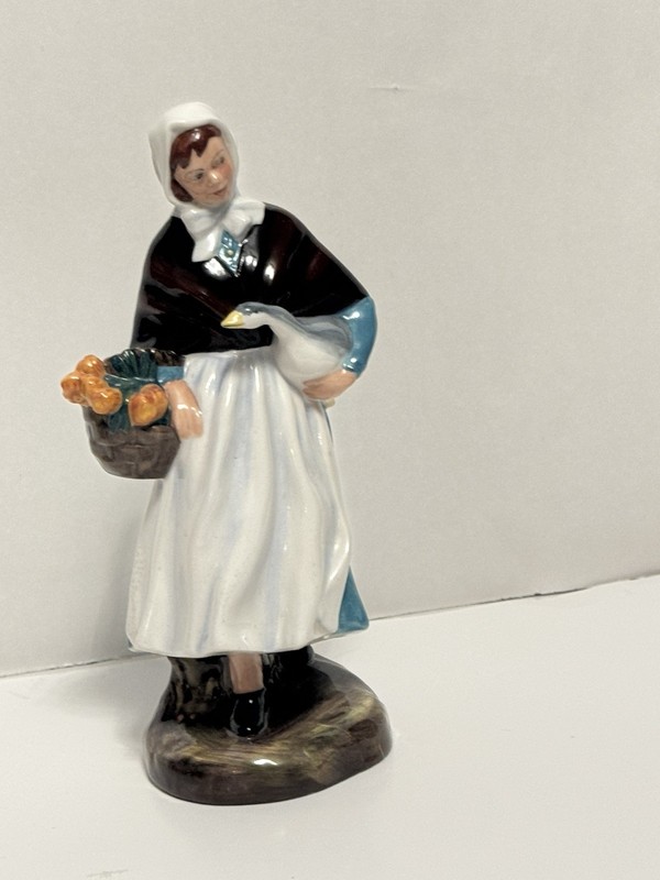 This is a Royal Doulton "Country Lass" porcelain figurine, model number HN 1991