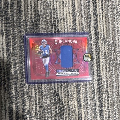 2024 Panini Obsidian Supernova Swatches Amon-Ra St. Brown Lions Red /75 MEM
