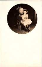 Little Girl Holding Doll Portrait Oval Framed Antique Real Photo Postcard