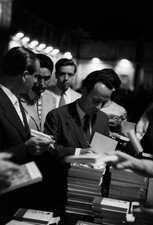 Italian poet writer Giorgio Bassani signing many copies of his boo- Old Photo