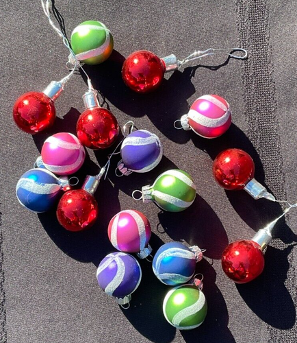Lot of 16 round Christmas balls with multicolor horizontal stripes in red, red-green, and red-purple on a black background.