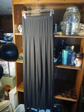 black, wide-leg, high-waisted palazzo pant with a ruched elastic waistband.