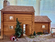 Handcrafted log cabin dollhouse with furnishings