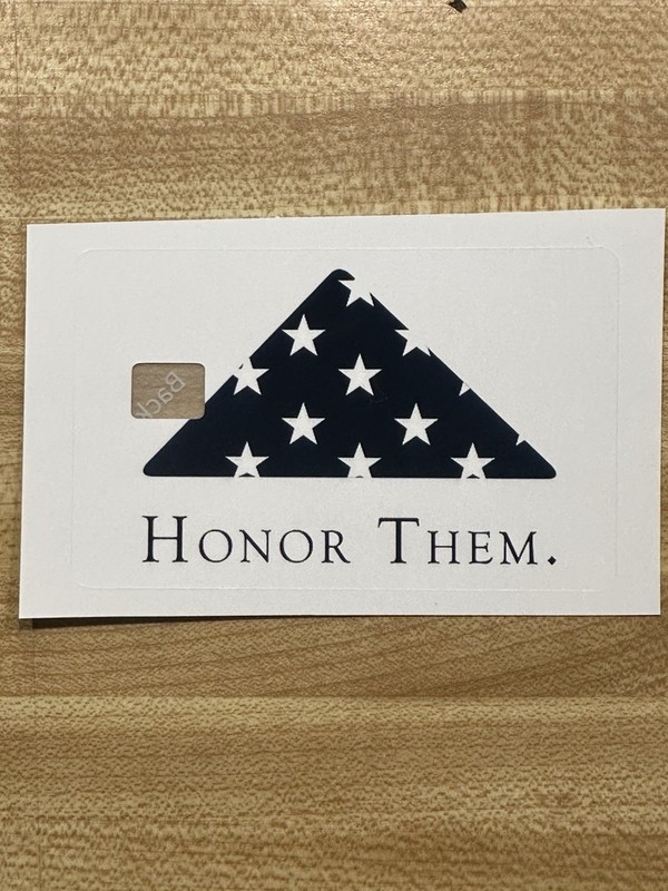 Folded American Flag “Honor Them” credit card skin.  Small chip.