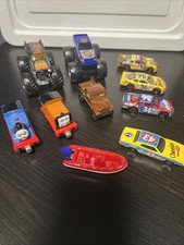 Lot Of Toy Cars With NASCAR Cars One Being Hot Wheels And A 1998 Matchbox Boat