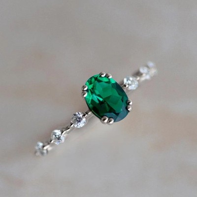 2Ct Oval Cut Simulated Emerald Solitaire with Accent Ring 14K White Gold Plated