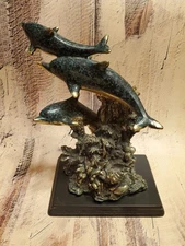 Three Dolphins Swimming Around Coral Reef Statue