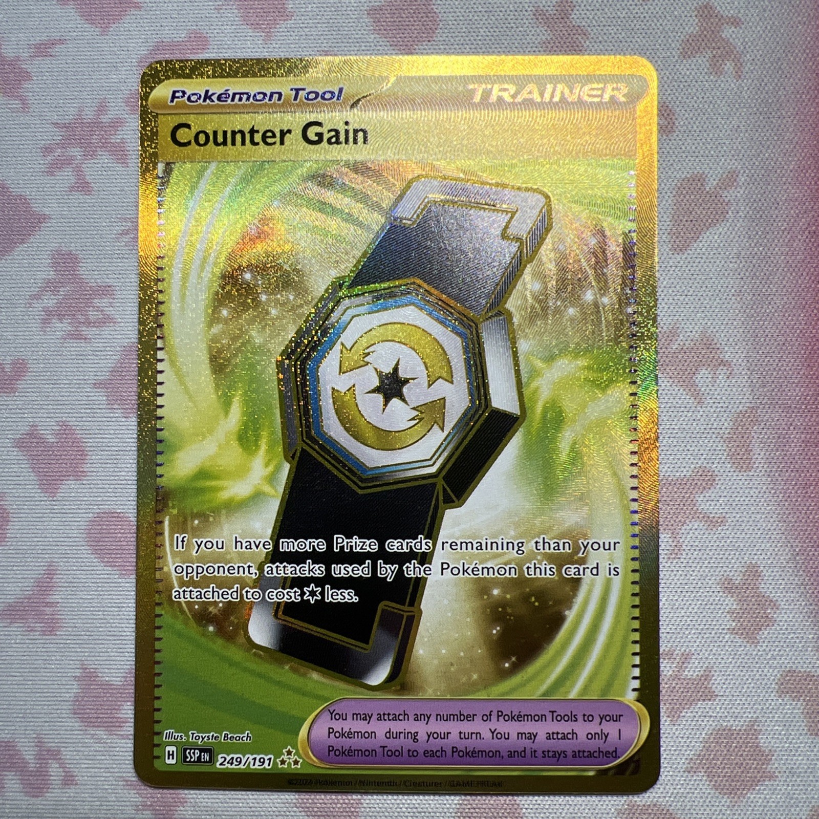 Counter Gain Gold 249/191 Pokemon Card Sv08: Surging Sparks Holo NM