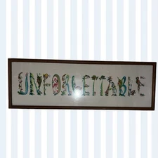 Decorative framed art with the word 'Unforgettable'. 33x12