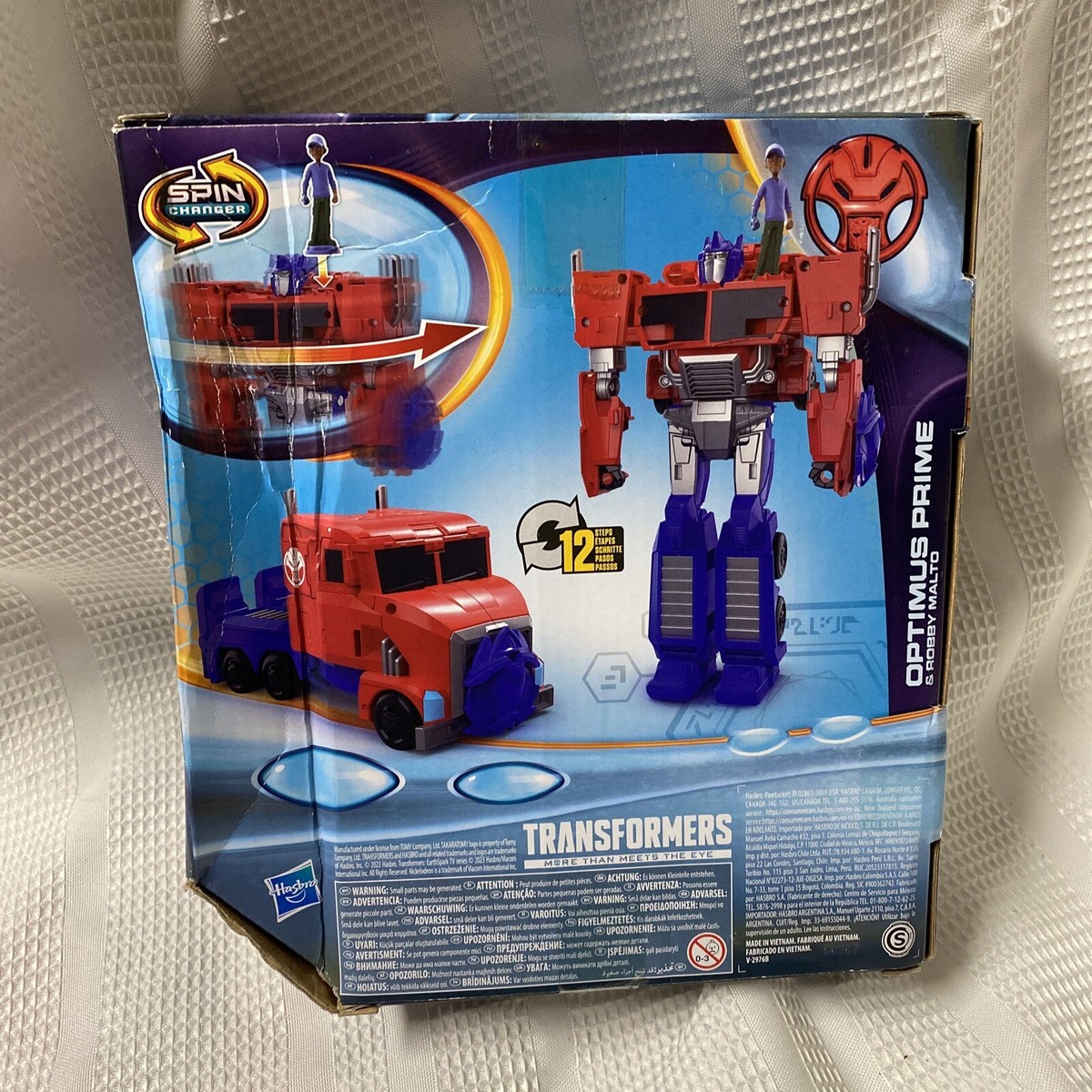 TRANSFORMERS EARTHSPARK SPIN CHANGER 8 INCH OPTIMUS PRIME AND 2