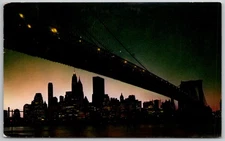 c1964 Postcard Night Fall In Lower Manhattan Brooklyn Bridge New York City NY