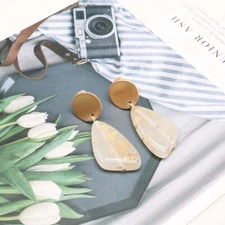 Clip on 2" matte gold earrings with dangle tan and glitter bead