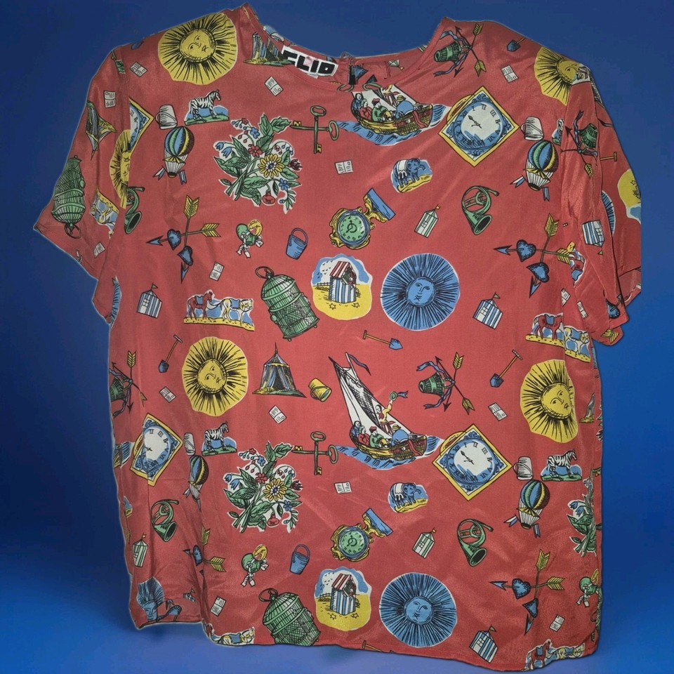 100% silk novelty graphic blouse from Clio — the kind of bold, kitschy vintage piece that stops people in their tracks at a thrift store.