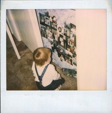 Old Vintage Photo COLOR POLAROID SOLO BOY LOOKING AT PHOTOGRAPHS FUNNY PICTURE