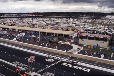 Big crowd gathers to watch NASCAR racing action under some dark om- Old Photo
