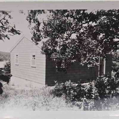Vintage B&W Photo Snapshot of Small Overgrown House Overlooking Lake Water