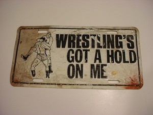 KILLER! used  "WRESTLING's GOT A HOLD ON ME" metal license plate FREE SHIP