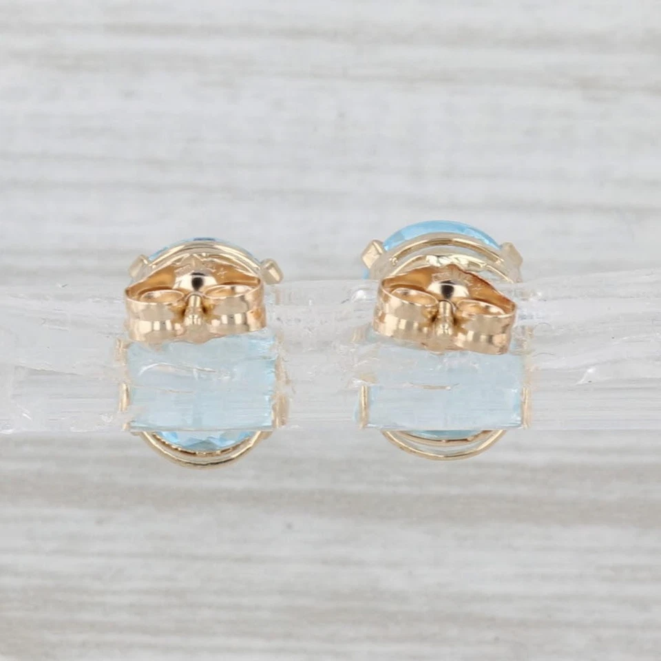 Aretes solitarios de oro amarillo de 14 k con topacio azul ovalado de 4,30 quilates Foto 4 de 4