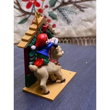 Christmas Tree Ornament An Elf on Reindeer Vixen’s back, cleaning her antlers  