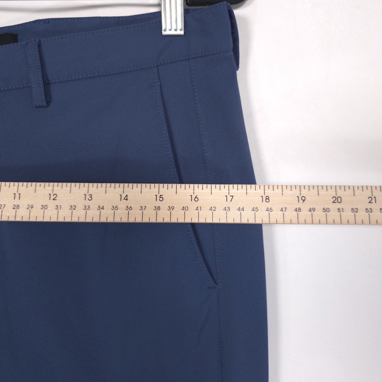 Blue 32 slim-fit THEORY men’s dress pants with front button closure, belt loops, and side pockets, laid flat on light surface.