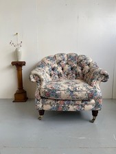 Vintage floral button back small club armchair with castor front feet