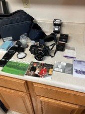 Canon T50 35mm SLR Camera. Lens Filters, 2 Flashes, Case, Manuals, etc.