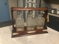 QUALITY GENTLEMEN’S  ANTIQUE GOLDEN OAK CASED,THREE BOTTLE TANTALUS  CIRCA 1910.