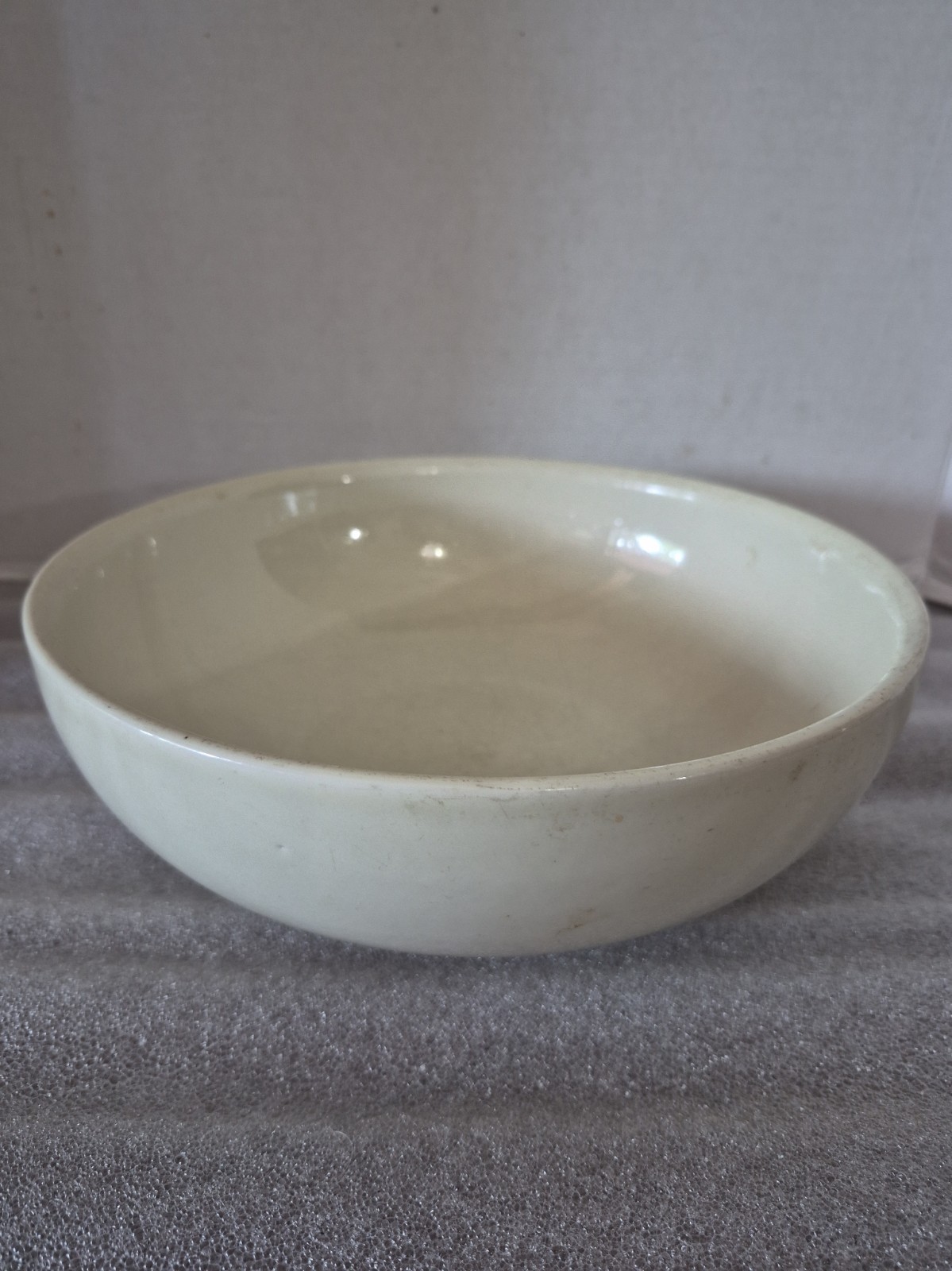 White eggshell ironstone bowl on a plain background.