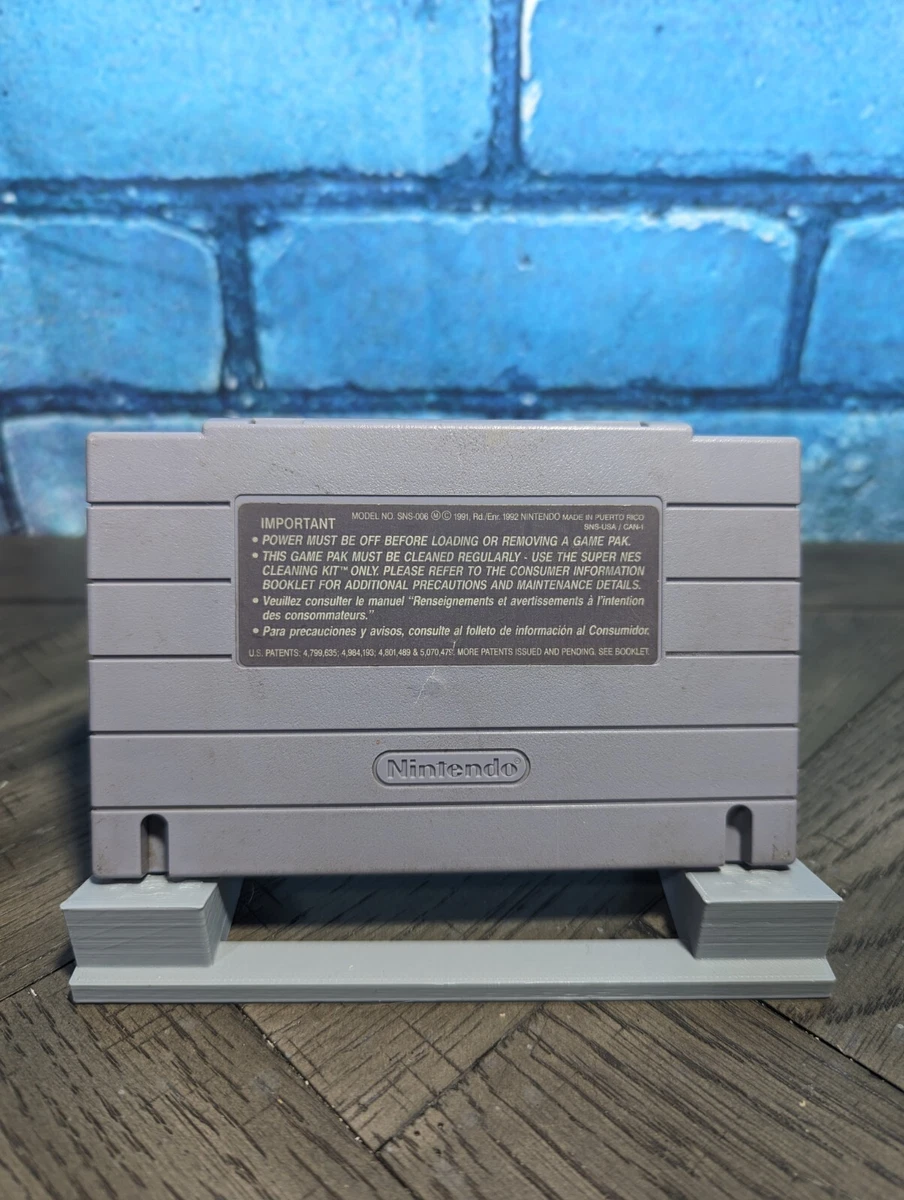Gray Nintendo Super Famicom cartridge back with printed labels, including important text and Nintendo logo.