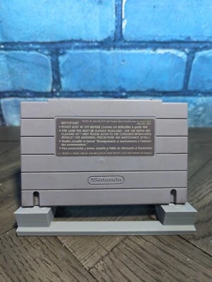 Gray Nintendo Super Famicom cartridge back with printed labels, including important text and Nintendo logo.