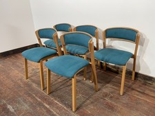 Set of 5 matching dining chairs in light wood with teal / light blue fabric